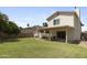 Large backyard features a covered patio perfect for entertaining friends and Gathering, and green lawn at 4615 W Boston St, Chandler, AZ 85226