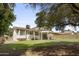 Spacious backyard featuring a covered patio, mature trees, and well-maintained lawn at 4615 W Boston St, Chandler, AZ 85226