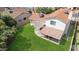 Aerial view of backyard featuring a green lawn, covered patio, and mature trees providing privacy at 4615 W Boston St, Chandler, AZ 85226