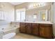 Bright bathroom with soaker tub, white countertops, and ample storage at 4615 W Boston St, Chandler, AZ 85226