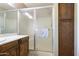 Bathroom featuring a shower with glass doors, wood cabinets, and a marble countertop at 4615 W Boston St, Chandler, AZ 85226