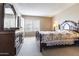 Main bedroom with dark furniture, floral bedding, and plenty of light at 4615 W Boston St, Chandler, AZ 85226