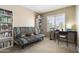Bedroom with futon, decorated with bookshelves, and a sewing table near a window at 4615 W Boston St, Chandler, AZ 85226