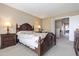Main bedroom with dark furniture, floral bedding, and plenty of light at 4615 W Boston St, Chandler, AZ 85226