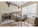 Bright dining area featuring laminate floors, a modern table setting, and natural light from the large window at 4615 W Boston St, Chandler, AZ 85226
