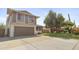 Two-story home featuring an attached garage, well-maintained lawn, and mature tree in a quiet neighborhood at 4615 W Boston St, Chandler, AZ 85226