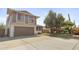 Two-story home with a brown garage door, mature tree and well-manicured landscaping at 4615 W Boston St, Chandler, AZ 85226