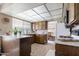 View of kitchen with wood cabinets, granite countertops, and light colored flooring at 4615 W Boston St, Chandler, AZ 85226