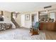 Living room with neutral walls, vinyl floors, rocking chair, and staircase at 4615 W Boston St, Chandler, AZ 85226