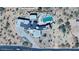 Aerial view of a modern home with a pool, patio, landscaped yard, and mountain views, showcasing luxury living at 5826 E Indian Bend Rd, Paradise Valley, AZ 85253