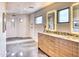 Modern bathroom with an elegant vanity, granite counters, and a luxurious glass-enclosed shower at 5826 E Indian Bend Rd, Paradise Valley, AZ 85253