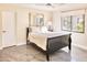 Clean bedroom with black frame bed, decorative mirror, and polished concrete floors at 5826 E Indian Bend Rd, Paradise Valley, AZ 85253