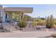 Contemporary home with desert landscaping, stone accents, and staircase to a balcony at 5826 E Indian Bend Rd, Paradise Valley, AZ 85253