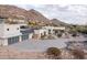 Stunning exterior of home featuring desert landscaping, a spacious driveway, and a mountain backdrop at 5826 E Indian Bend Rd, Paradise Valley, AZ 85253