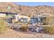 Modern desert home with clean lines, large windows, native landscaping, and hillside views at 5826 E Indian Bend Rd, Paradise Valley, AZ 85253