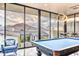 Game room with pool table and scenic mountain views through walls of glass at 5826 E Indian Bend Rd, Paradise Valley, AZ 85253