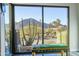Sunny interior view with large windows, scenic mountain views, and a colorful bench, bringing nature inside at 5826 E Indian Bend Rd, Paradise Valley, AZ 85253