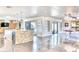 Bright kitchen featuring an expansive island with seating and modern lighting at 5826 E Indian Bend Rd, Paradise Valley, AZ 85253
