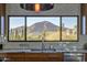 Kitchen sink with a window view, stainless steel appliances, and white tile backsplash with natural light at 5826 E Indian Bend Rd, Paradise Valley, AZ 85253