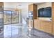 Living area with custom cabinets, stainless steel fridge, and beautiful desert views at 5826 E Indian Bend Rd, Paradise Valley, AZ 85253