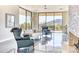 Living room with natural light, a fireplace, and desert views at 5826 E Indian Bend Rd, Paradise Valley, AZ 85253