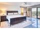 Bright main bedroom boasts a sliding door, a ceiling fan, and stylish ensuite access with barn door entry at 5826 E Indian Bend Rd, Paradise Valley, AZ 85253