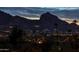 Scenic night view of twinkling city lights and a silhouetted mountain range, perfect for evening ambiance at 5826 E Indian Bend Rd, Paradise Valley, AZ 85253