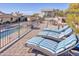 Relaxing rooftop patio features comfortable lounge chairs, dining set, and scenic views of the surrounding area at 5826 E Indian Bend Rd, Paradise Valley, AZ 85253