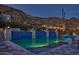 Luxurious pool with vibrant blue tile, poolside lounging, and desert views, ideal for relaxation and entertainment at 5826 E Indian Bend Rd, Paradise Valley, AZ 85253
