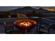 Inviting rooftop deck with a fire pit and stunning mountain views at dusk at 5826 E Indian Bend Rd, Paradise Valley, AZ 85253