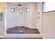 Close up of a shower with river rock basin, rainfall shower head, and artistic wall tile at 5826 E Indian Bend Rd, Paradise Valley, AZ 85253