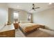 Bright bedroom with striped bedding, dresser, and ceiling fan at 5929 S Del Rancho --, Mesa, AZ 85212