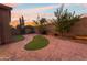 Landscaped backyard with stamped concrete and grassy areas at 6230 W Montebello Way, Florence, AZ 85132