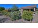 Landscaped backyard with mature plants, flagstone path, and citrus tree at 6399 W Saratoga Way, Florence, AZ 85132