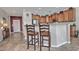 Kitchen with wood cabinets, granite counters, and breakfast bar at 6399 W Saratoga Way, Florence, AZ 85132