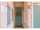 Inviting condo entryway with teal door and wreath at 6535 E Superstition Springs Blvd # 124, Mesa, AZ 85206