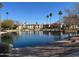 Community lake view with palm trees and building reflection at 6535 E Superstition Springs Blvd # 124, Mesa, AZ 85206