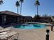 Community swimming pool with lounge chairs and a spa at 6535 E Superstition Springs Blvd # 124, Mesa, AZ 85206