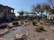 Community water feature with waterfall and landscaping at 6535 E Superstition Springs Blvd # 124, Mesa, AZ 85206