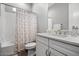 Simple bathroom with single vanity and tub shower at 6607 E Libby St, Phoenix, AZ 85054