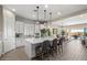 Modern kitchen with white cabinets, large island, and stainless steel appliances at 6607 E Libby St, Phoenix, AZ 85054