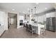 Bright kitchen features white cabinets, stainless steel appliances, and an island at 6607 E Libby St, Phoenix, AZ 85054