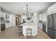 Elegant kitchen with white cabinetry, large island, and wine storage at 6607 E Libby St, Phoenix, AZ 85054