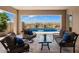 Covered patio with seating area and view of a sparkling pool at 6607 E Libby St, Phoenix, AZ 85054