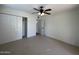 Bright bedroom with ceiling fan and mirrored closet doors at 6711 N 14Th Pl, Phoenix, AZ 85014