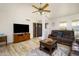 Bright living room with hardwood floors and large TV at 7928 E Madero Ave, Mesa, AZ 85209