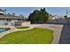 Beautiful backyard featuring a built-in bar, a patch of artificial turf, and desert landscaping at 811 W Northern Ave, Phoenix, AZ 85021