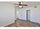 Bedroom featuring white walls, wood-look floors, a ceiling fan, and a closet at 811 W Northern Ave, Phoenix, AZ 85021