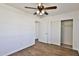 Bedroom with minimalist decor, wood-look floors, a ceiling fan, and a closet at 811 W Northern Ave, Phoenix, AZ 85021