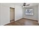 Bright bedroom with wood-look floors, a ceiling fan, and a closet with sliding doors at 811 W Northern Ave, Phoenix, AZ 85021